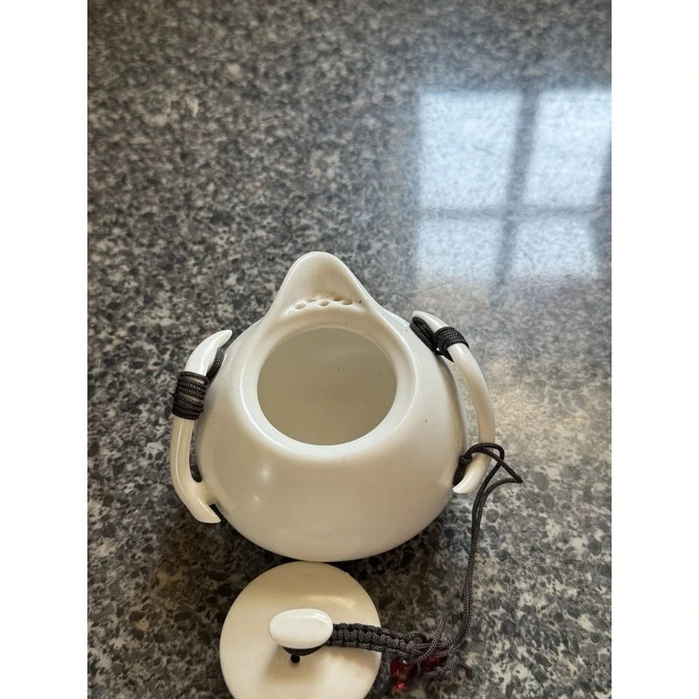 Compact travel tea pot white ceramic with decorative cord